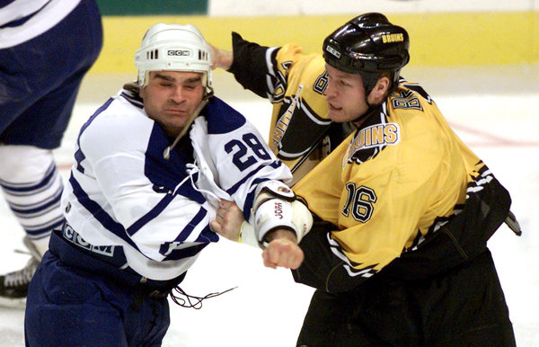 Tie Domi, left, took on Ken Belanger in one of his 333 N.H.L. fights. "The life of an enforcer is thankless,” he wrote in his book "Shift Work." JIM BOURG / REUTERS