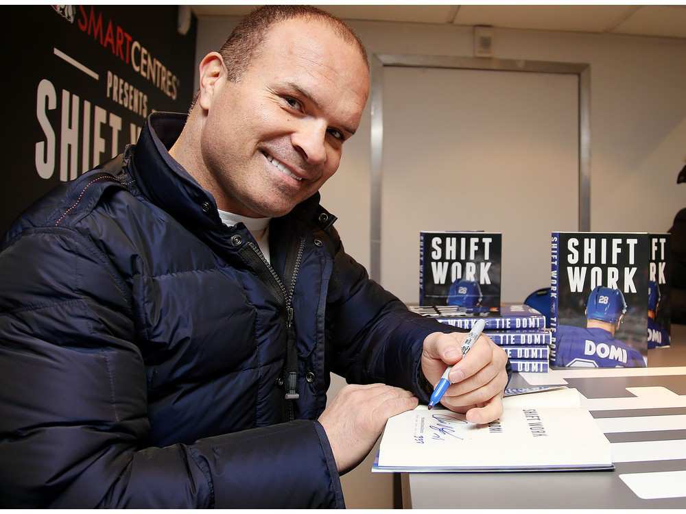Toronto Maple Leafs legend Tie Domi signs his book Shift Work for fans while on a book tour.